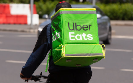 Bucharest, Romania - May 12, 2019: An Uber Eats food delivery courier delivers food in Bucharest, Romania.のeditorial素材