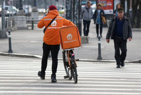 Bucharest, Romania - February 01, 2019: A Takeaway Food Delivery courier delivers food in Bucharest, Romania.のeditorial素材