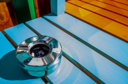 Bucharest, Romania - May 21, 2019: An ashtray full of smoked cigarettes on a chair in front of a coffee shop in Bucharest. European laws prohibit smoking in enclosed public places like coffee shops.のeditorial素材
