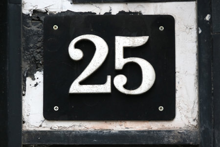 Bucharest, Romania - November 15, 2018: House number 25 is seen on a grunge wall in Bucharest. This image is for editorial use only.のeditorial素材