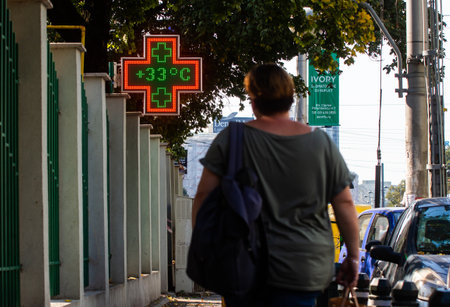 Bucharest, Romania - September 30, 2019: 31 degrees celsius (87.8 fahrenheit) is the temperature displayed by a digital thermometer on a hot summer outside a pharmacy. This image is for editorial use only.のeditorial素材