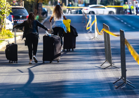 Bucharest, Romania - October 13, 2019: A group of women tourists carrying suitcases on a street in Bucharest, Romania.のeditorial素材