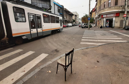 Bucharest, Romania - October 24, 2019: An old chair that no one is sitting on is seen on a sidewalk at an intersection in Bucharest. This image is for editorial use only.のeditorial素材