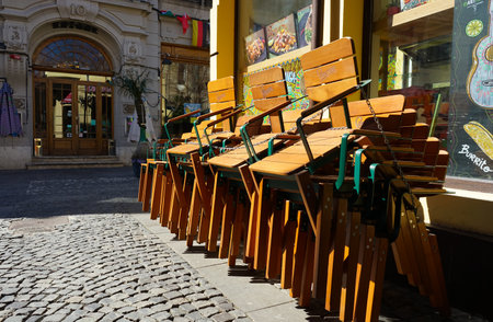 Bucharest, Romania - March 16, 2020: Chairs tied in chains near a closed mexican food restaurant. In Romania restaurants are temporary closed during the state of emergency due to coronavirusのeditorial素材