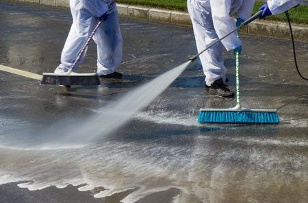 Bucharest, Romania - April 03, 2020: Sanitation employees clean the streets with environmentally active foam in an attempt to eliminate the spread of coronavirus.のeditorial素材