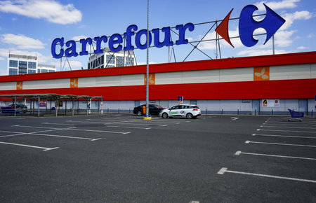 Bucharest, Romania - April 23, 2020: Empty parking lot of French multinational retailer Carrefour is seen at the Orhideea Shopping Center in Bucharest. Romania is in lockdown due to coronavirus.のeditorial素材