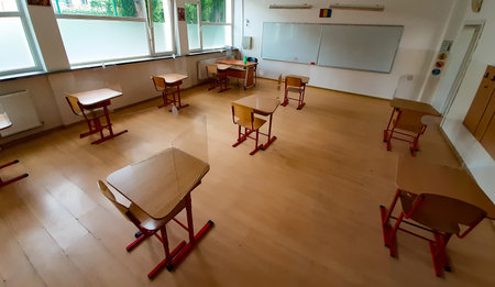 Bucharest, Romania - May 29, 2020: School classroom with the desks spaced to avoid the risk of coronavirus infection during exams is presented to members of the press by the mayor of sector 4.のeditorial素材