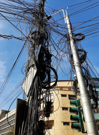Bucharest, Romania - September 20, 2020: Many internet and communications cables hang out on pillars in Bucharest.のeditorial素材