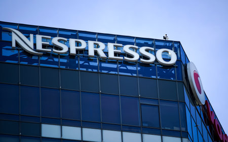 Bucharest, Romania - January 21, 2021: A logo of Nespresso, coffee capsules, coffee pods, coffee machines maker and operating unit of the Switzerland Nestle Group, is displayed on the top of a building, in Bucharest, Romania.のeditorial素材