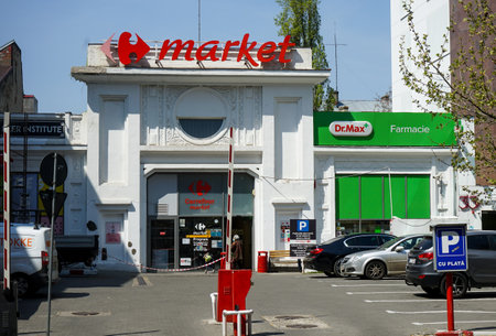Bucharest, Romania - April 26, 2021: Carrefour Market, in former garage builded in 1926, Auto-Garajului A.C. Tartasescu & R. Munteneanu, which was mainly Peugeot and LATIL dealer.