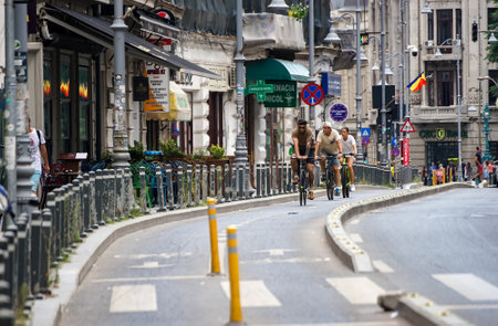 Bucharest, Romania - August 12, 2021: People ride bicycles on the Victory Avenue bicycle track in Bucharest, Romania. This image is for editorial use only.のeditorial素材