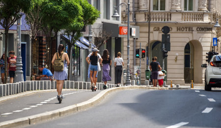 Bucharest, Romania - August 12, 2021: People ride electric scooter on the Victory Avenue bicycle track in Bucharest, Romania.のeditorial素材
