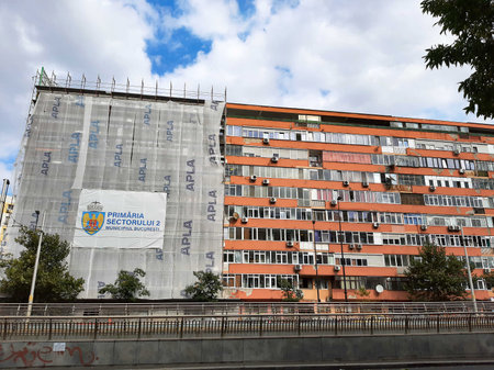 Bucharest, Romania - October 06, 2021: A block of flats is rehabilitated with expanded polystyrene coating for better thermal insulation.のeditorial素材
