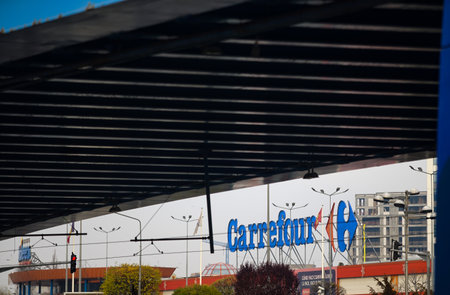 Bucharest, Romania - December 09, 2021: The logo of the French multinational retailer Carrefour is seen above its shop located in the Orhideea Shopping Center in Bucharest.のeditorial素材