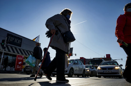 Bucharest, Romania - January 19, 2022: Pedestrians cross the street near Crangasi market in Bucharest, Romania.のeditorial素材