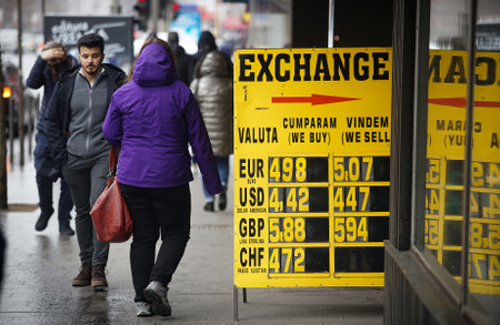 Bucharest, Romania - March 01, 2022: The exchange rate of the Leu-Euro, which exceeds the psychological threshold of 5 lei, is displayed on a yellow board at the entrance of a currency exchange officeのeditorial素材