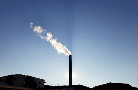 Bucharest, Romania - January 14, 2022: Chimney of CET Progresul power plant, pollute with smoke from the burning of heating oil and gases, in the south of Bucharest.のeditorial素材