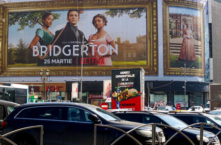 Bucharest, Romania - March 24, 2022: Extra large banner advertising Bridgerton TV Series is displayed on the Unirea Shopping Center, in downtown Bucharest.のeditorial素材