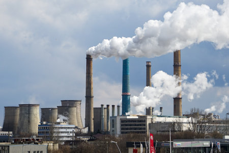 Bucharest, Romania - March 10, 2022: The chimneys of the CET Sud power plant, which pollute with smoke from the burning of heating oil and gases.のeditorial素材