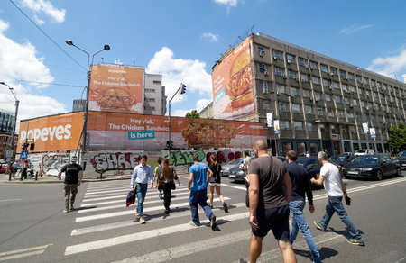 Bucharest, Romania - June 06, 2022: People cross the street on a hot day in Bucharest.のeditorial素材