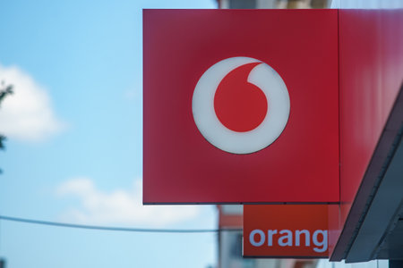 Bucharest, Romania - August 04, 2022: Logo of Orange, French telecommunications company and Vodafone, British telecommunications company is displayed on the top of a GSM shop in Bucharest, Romania.のeditorial素材