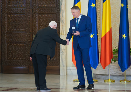 Bucharest, Romania - January 13, 2023: Puiu Manu, graphic designer and comic book creator, is decorated by the President of Romania Klaus Iohannis on the occasion of the National Culture Day.のeditorial素材