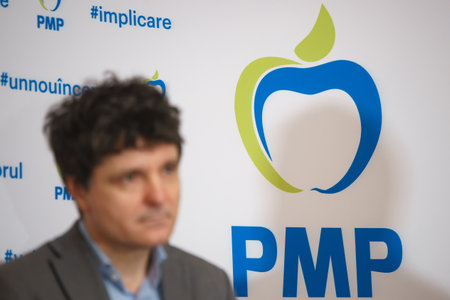 Bucharest, Romania. 28th Feb, 2023: The logo of the Popular Movement Party is seen behind the blurred image of the general mayor of Bucharest, Nicusor Dan.のeditorial素材
