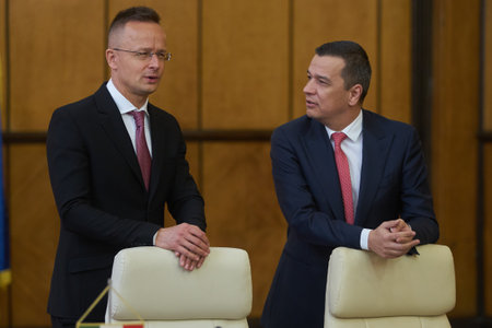 Bucharest, Romania. 4th Apr, 2023: Peter Szijjarto, left, The Minister of Foreign Affairs and Foreign Trade of Hungary, speaks with Sorin Grindeanu, the Romanian Minister of Transport, during the signing ceremony of the agreement between the Government ofのeditorial素材