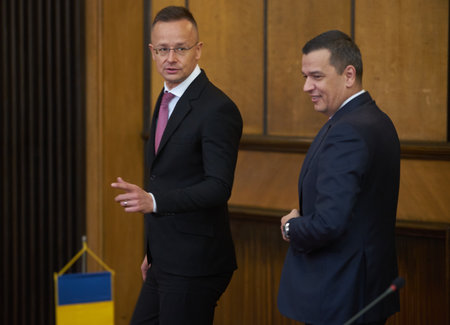 Bucharest, Romania. 4th Apr, 2023: Peter Szijjarto, left, The Minister of Foreign Affairs and Foreign Trade of Hungary, speaks with Sorin Grindeanu, the Romanian Minister of Transport, during the signing ceremony of the agreement between the Government ofのeditorial素材
