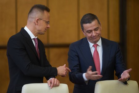 Bucharest, Romania. 4th Apr, 2023: Peter Szijjarto, left, The Minister of Foreign Affairs and Foreign Trade of Hungary, speaks with Sorin Grindeanu, the Romanian Minister of Transport, during the signing ceremony of the agreement between the Government ofのeditorial素材