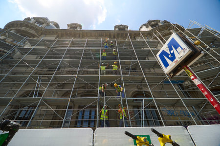 Bucharest, Romania - June 22, 2023: The builders are assembling the scaffolding necessary for the restoration work on the facades of the Palace of the University of Bucharest.のeditorial素材