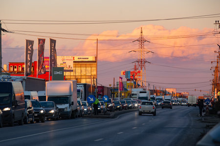 Afumati, Romania - January 16, 2024: Car traffic slightly hampered due to trucks and tractors parked on the road during the transporters and farmers protest, in Afumati, 12 km north of Bucharest.のeditorial素材