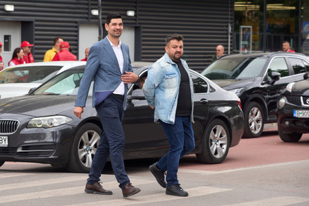 Bucharest, Romania. 27th May, 2024: George Tuta (L), the candidate of the National Liberal Party (PNL) for the Mayor of Sector 1, arrives at an electoral campaign action in the agri-food market "Piata 16 Februarie" in north Bucharest. Romanians are calledのeditorial素材