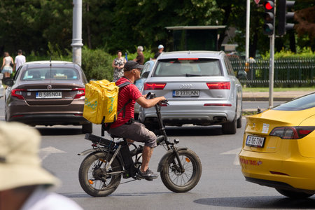 Bucharest, Romania. 21st June, 2024: A Glovo food delivery courier delivers food in Bucharest, Romania.のeditorial素材