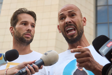 Bucharest, Romania. 22dn Aug, 2024: Andrew Tate (R) and his brother Tristan Tate (L) leave the Bucharest Court, Andrew under house arrest and Tristan under judiciary control, after being held in custody for 24 hours.のeditorial素材