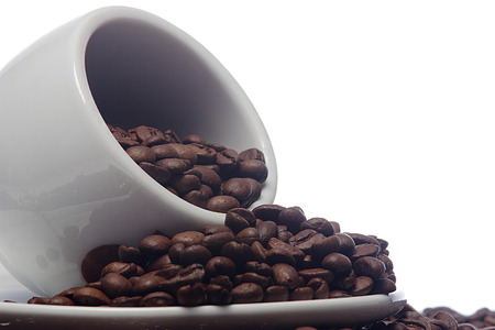 coffee beans and a white coffee cup