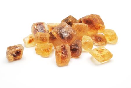 Unrefined cane sugar heap on white backgroundの写真素材