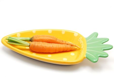 Two carrots in funny plate on white backgroundの写真素材