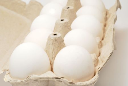 Eggs in container on white backgroundの写真素材