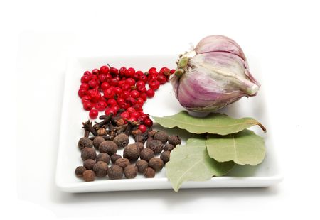 Red pepper, cloves, bay leafs and garlic isolated on white backgroundの写真素材