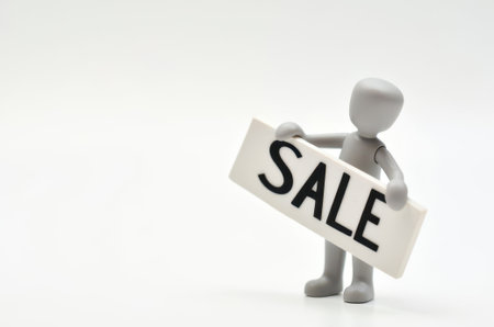 Miniature people : Man holding sale sign on white background, business conceptの素材