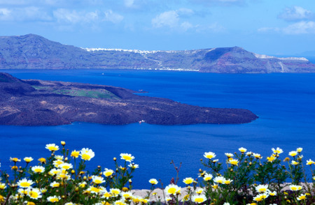Summer sunny morning on the island of Santorini, Greece. Blue sea, blue sky with clouds against the background of the island. Euro trip.の写真素材