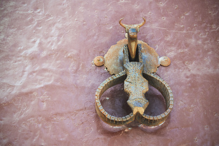 Ronda, Spain, February 2019. Metallic old door handle in the shape of a bull. House near the famous bullring Plaza de Toros.のeditorial素材