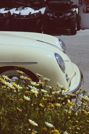 Santorini, Greece, April 2019. A small car in a retro style in the parking lot. Travelling by car. Yellow convertible on a sunny day rented. Car rental on the Greek island. Tinted.のeditorial素材