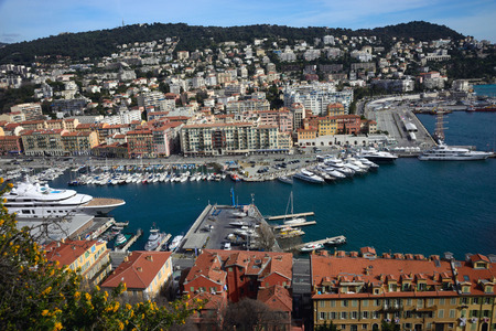 Nice, France, March 2019. Port of the French city of Nice. Private yachts and boats are parked near the coast. Beautiful mountains, the port, the lighthouse and the turquoise sea - a great place to relax.のeditorial素材