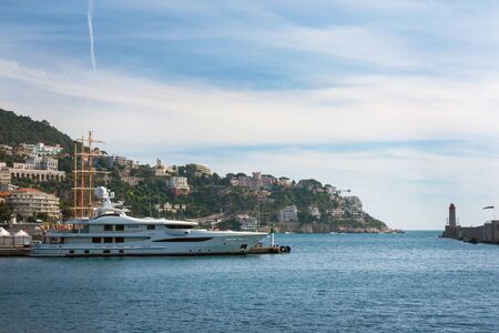 Nice, France, March 2019. Azure sea, yachts, lighthouse. Port and parking of private yachts in Nice. Luxurious comfortable life.のeditorial素材