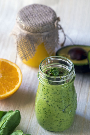 Thick nutritious smoothies, which include: avocado, apple, banana, spinach, orange juice, honey, flax seeds, mint and olive oil. Proper nutrition. Healthy lifestyle.の写真素材