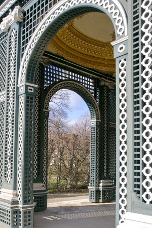 Vienna, Austria, March 2018. View of the garden through the arch of the old wooden arbor in the garden of Schonbrunn Palace, the imperial summer residence of the Habsburg monarchs in early spring.のeditorial素材