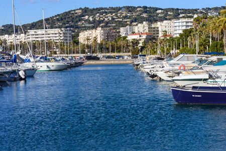 Cannes, France, March 2019. White expensive yachts on a background of mountains on a sunny day. Yacht parking in Cannes, France. Mediterranean Sea.のeditorial素材