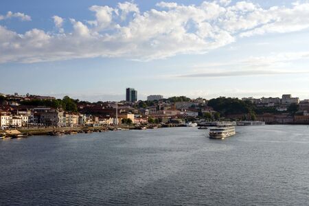 Beautiful view of the Douro River in the city of Porto, Portugal. River, bridge and roofs of houses in the light of the setting sun. An interesting trip to Portugal.のeditorial素材